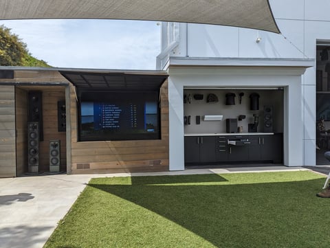 Modern house exterior with two-car garage, contemporary architectural design, and manicured lawn in front
