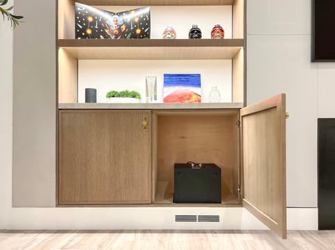 Modern wall-mounted shelving unit with open and closed storage, displaying decorative items and accessories with cabinet doors open